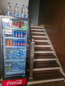 a refrigerator full of water and soda on the stairs at Hotel Right Choice in Indore