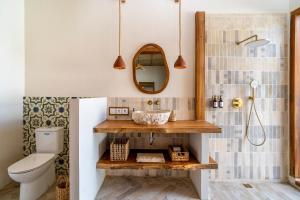a bathroom with a sink and a toilet at Teman Private villa with pool in Gili Islands