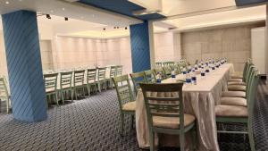 a dining room with a long table and chairs at Hotel The Enchanted Residence in Dhaka