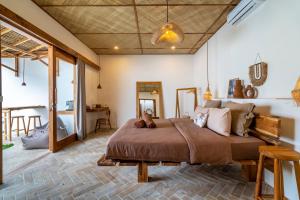 a bedroom with a large bed in a room at Teman Private villa with pool in Gili Islands