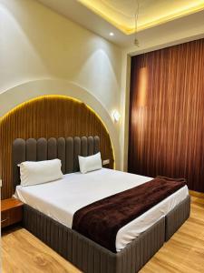 a bedroom with a large bed in a room at Hotel Cloud 9 in Amritsar