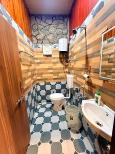 a bathroom with a toilet and a sink at Dev Cottage in Mount Ābu +47 photos