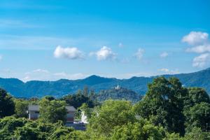 a view of the mountains and trees in the foreground at Coasta Wings Hostel in Nathon Bay