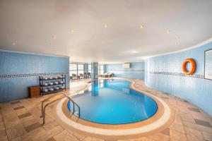 a large swimming pool in a hotel room at Doha Central Plaza Hotel in Doha