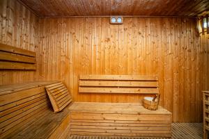 a wooden sauna with a bench and a clock on the wall at Doha Central Plaza Hotel in Doha +73 photos