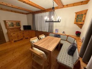 a dining room with a wooden table and chairs at Holiday home with panoramic views in Tulfes