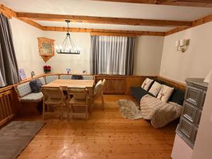 a living room with a table and a couch at Holiday home with panoramic views in Tulfes +28 photos