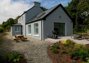 a house with a picnic table and a grill at Willow in Clifden