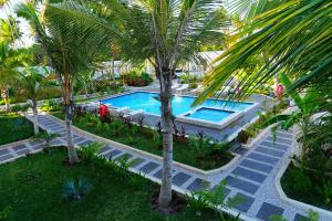 an overhead view of a swimming pool with palm trees at Changarawe Hotel & Retreat in Pongwe