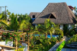 a resort with a thatched roof and a pool at Changarawe Hotel & Retreat in Pongwe +120 photos