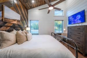 a bedroom with a bed and a ceiling fan at Spa Game Room Sunset Views 5BR Cabin in Broken Bow