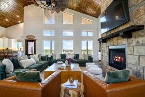 a large living room with couches and a fireplace at Spa Game Room Sunset Views 5BR Cabin in Broken Bow