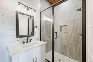 a bathroom with a sink and a shower at Spa Game Room Sunset Views 5BR Cabin in Broken Bow +43 photos