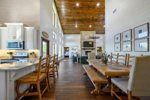 a kitchen and dining room with a long table and chairs at Spa Game Room Sunset Views 5BR Cabin in Broken Bow