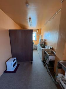 a small kitchen with a sink and a counter top at 駅本ビル民宿4階 in Yuzawa