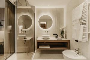 a bathroom with a sink and a shower at Hotel Hell in Ortisei