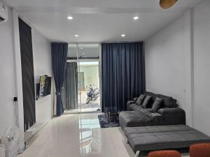 a living room with a couch and a window at K Siri House Hatyai in Hat Yai