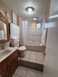 a bathroom with a tub and a toilet and a sink at Casa Rosarito beach in Rosarito Beach +39 photos