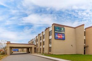 a building with a sign on the side of it at MainStay Suites Lansing West in Lansing