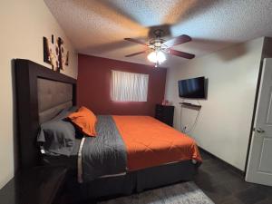 a bedroom with a bed and a ceiling fan at Casa Rosarito beach in Rosarito Beach