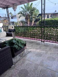 a patio with a bench and a fence with plants at Casa Rosarito beach in Rosarito Beach