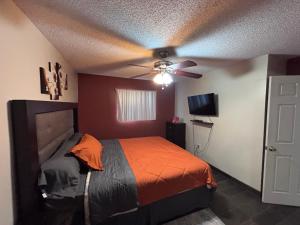 a bedroom with a bed and a ceiling fan at Casa Rosarito beach in Rosarito Beach