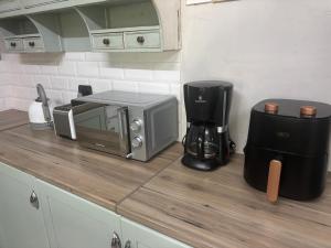 a kitchen counter with a toaster and a coffee maker at Buchan's corner Unit 1 in Hartbeespoort