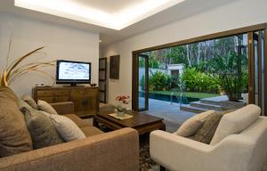 a living room with two couches and a television at Villa Kama in Rawai Beach