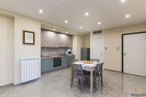 a kitchen with a table and chairs in a room at Alma Mare in Crotone