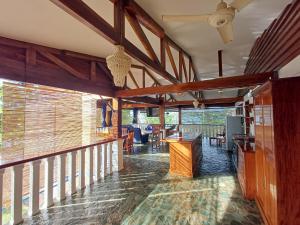 a room with a balcony with wooden beams at Rainbow Bay Beach & Dive Resort in Siquijor