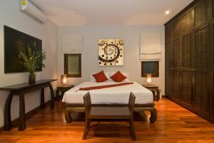 a bedroom with a bed and a table and chairs at Villa Kama in Rawai Beach
