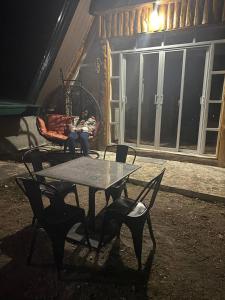 a woman is sitting in a chair in a chair sqor at Bilza A-House in Sagada