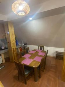 a dining room with a table and chairs and a light at Bilza A-House in Sagada