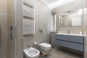 a bathroom with a toilet and a sink and a mirror at Alma Mare in Crotone +13 photos