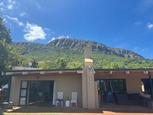 a building with a mountain in the background at Buchan's Corner Unit 2 in Hartbeespoort