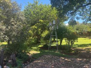 a windmill in the middle of a yard with trees at Buchan's Corner Unit 2 in Hartbeespoort