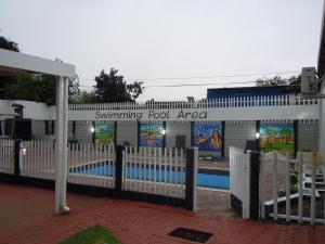 a fence in front of a swimming pool area at Daeka Guesthouse in Kempton Park