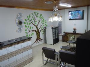 a hair salon with a tree mural on the wall at Daeka Guesthouse in Kempton Park