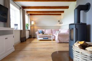 a living room with a couch and a stove at Ferienwohnung Gut Immenhof in Malente