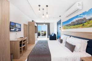 a hotel room with a bed and a desk at Georges Boutique Living in Xagħra