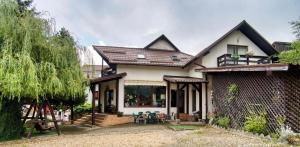 a house with a porch and a patio at Casa Preto E Branco in Moieciu de Jos