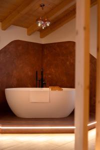 a bath tub in a bathroom with a ceiling at Guest House Fleim in Panchià +43 photos