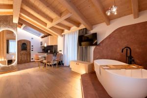 a large bathroom with a tub and a table at Guest House Fleim in Panchià