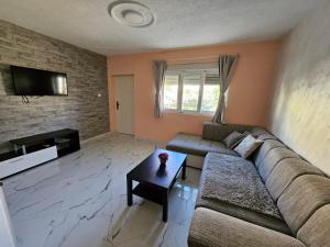 a living room with a couch and a table at Apartments Bulatović in Bar