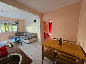 a living room with a table and a couch at Apartments Bulatović in Bar