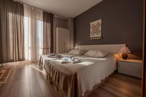a bedroom with a bed and a large window at Къща за гости В 12 и 5 in Dolna Banya +46 photos