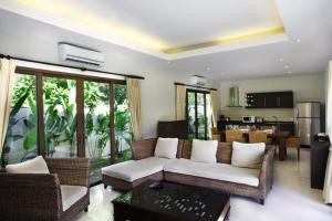 a living room with a couch and a table at Villa Lombok by Holiplanet in Rawai Beach