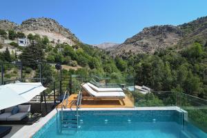a house with a swimming pool and a mountain at Arawan - Boutique Art Hotel - Tannourine in Batroûn