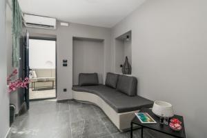 a living room with a couch and a table at Uncle's House Junior Suite INDOOR Pool in Adamantas