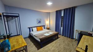 a bedroom with a bed with blue walls and a window at Blueplace บลูเพลส in Ban Talat Rangsit +15 photos